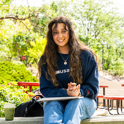 Female student sitting in courtyard