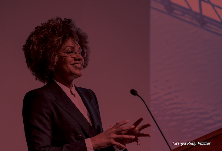 LaToya giving her lecture with a maroon filter covering the whole image