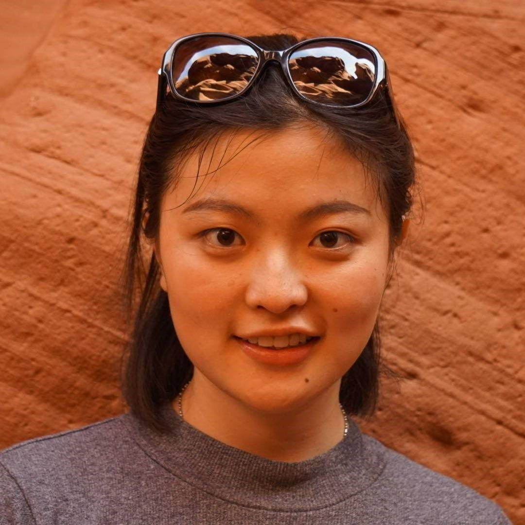 Headshot of Yang with red rocks as a background